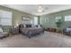Spacious main bedroom with neutral decor, ceiling fan, and several windows for natural light at 18460 E Peachtree Blvd, Queen Creek, AZ 85142