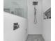 Sleek walk-in shower with rainfall showerhead and modern tile design at 18460 E Peachtree Blvd, Queen Creek, AZ 85142