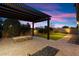 Inviting backyard features a stone fire pit, pergola, and artificial grass at 1874 E Crescent Way, Chandler, AZ 85249