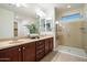 Bathroom featuring a double vanity with granite counters and glass-enclosed shower at 1874 E Crescent Way, Chandler, AZ 85249