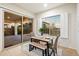 Cozy dining nook with a table and bench seating, sliding glass door, and large windows offering natural light at 1874 E Crescent Way, Chandler, AZ 85249