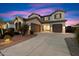 Elegant two-story home with a three-car garage, well-maintained landscaping, and a spacious driveway at 1874 E Crescent Way, Chandler, AZ 85249