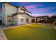 Elegant two-story home with a spacious backyard, artificial turf, and a pergola-covered fire pit at 1874 E Crescent Way, Chandler, AZ 85249