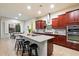 Modern kitchen with granite countertops, dark wood cabinets, stainless steel appliances, and a center island at 1874 E Crescent Way, Chandler, AZ 85249