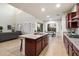 Bright open kitchen featuring an island, granite countertops, and a view of the living area and dining space at 1874 E Crescent Way, Chandler, AZ 85249
