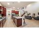 Open-concept kitchen with stainless steel appliances, dark wood cabinets, an island, and stairs to an upper level at 1874 E Crescent Way, Chandler, AZ 85249