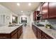 Spacious kitchen features an island with granite countertops, stainless appliances, and ample cabinet space at 1874 E Crescent Way, Chandler, AZ 85249