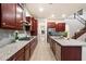 Contemporary kitchen showcasing granite countertops, stainless steel appliances, and an open layout leading to a staircase at 1874 E Crescent Way, Chandler, AZ 85249