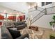 Open-concept living area adjoining a modern kitchen, featuring stylish furniture and staircase to the upper floor at 1874 E Crescent Way, Chandler, AZ 85249