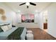 Bright main bedroom with modern ceiling fan, tan carpet, and ensuite bathroom entrance at 1874 E Crescent Way, Chandler, AZ 85249