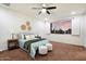 Bright main bedroom with modern ceiling fan, woven wall decorations, and tan carpet at 1874 E Crescent Way, Chandler, AZ 85249