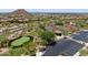 Beautiful aerial view showcasing the community's lush landscaping, tennis courts, putting green, and well-maintained surroundings at 1903 N Lynch --, Mesa, AZ 85207