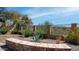 Landscaped backyard featuring desert plants, decorative stone walls, and views of the surrounding desert landscape at 1903 N Lynch --, Mesa, AZ 85207