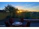Cozy backyard featuring a fire pit with seating, desert landscaping, and scenic sunset views at 1903 N Lynch --, Mesa, AZ 85207