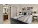 Bedroom with ensuite bathroom featuring neutral decor, a queen bed, and stylish lighting fixtures at 1903 N Lynch --, Mesa, AZ 85207