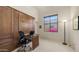 Bright, carpeted bedroom featuring a built-in Murphy bed with desk, and window offering views of the backyard at 1903 N Lynch --, Mesa, AZ 85207