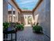 Charming courtyard featuring a brick patio, lounge seating, and an arched gate leading to a serene outdoor space at 1903 N Lynch --, Mesa, AZ 85207