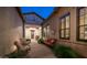 Inviting courtyard with cozy seating, brick pavers, and views of the home's architectural details at 1903 N Lynch --, Mesa, AZ 85207