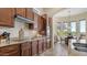 Modern kitchen with custom cabinetry, granite countertops, stainless steel appliances, and a view of the breakfast nook at 1903 N Lynch --, Mesa, AZ 85207