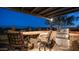 Well-equipped outdoor kitchen with a built-in grill, bar seating, and a pergola-covered dining area at 1903 N Lynch --, Mesa, AZ 85207