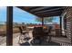 A covered outdoor kitchen features a built-in grill, bar seating, and stylish pergola, perfect for entertaining at 1903 N Lynch --, Mesa, AZ 85207