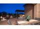 Covered patio featuring a dining table, chairs, an outdoor kitchen, and a fire pit area for ultimate outdoor enjoyment at 1903 N Lynch --, Mesa, AZ 85207