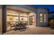 The covered patio includes a dining table and chairs, with views of the serene backyard and interior lighting at 1903 N Lynch --, Mesa, AZ 85207