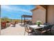 Inviting backyard patio with a dining area, fire pit with chairs, and a built-in BBQ, perfect for outdoor relaxation at 1903 N Lynch --, Mesa, AZ 85207