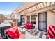 Cozy back patio features a fire pit, pergola, grill and stylish red outdoor furniture at 19815 N 49Th Ave, Glendale, AZ 85308