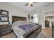 Spacious bedroom features a large bed, wood-look flooring, and view into ensuite bath at 19815 N 49Th Ave, Glendale, AZ 85308
