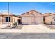 Charming single-story home with a two-car garage and well-maintained desert landscaping under a clear, sunny sky at 19815 N 49Th Ave, Glendale, AZ 85308