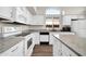 Bright kitchen featuring white cabinetry, granite countertops, stainless appliances, and tile backsplash at 19815 N 49Th Ave, Glendale, AZ 85308