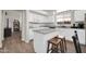 Well-lit kitchen featuring granite counters, an island with bar stool seating, and stainless steel appliances at 19815 N 49Th Ave, Glendale, AZ 85308