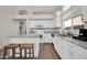 Modern kitchen features white cabinets, an island with seating, granite countertops, and stainless steel appliances at 19815 N 49Th Ave, Glendale, AZ 85308