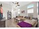 Cozy living room with vaulted ceilings, plush sectional sofa, modern ceiling fan, and ample natural light at 19815 N 49Th Ave, Glendale, AZ 85308