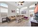 Open living room design with high ceilings, sectional sofa, decorative art, and wood-look flooring at 19815 N 49Th Ave, Glendale, AZ 85308