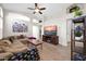 Inviting living room featuring a large sectional sofa, vaulted ceilings, and warm wood-look flooring at 19815 N 49Th Ave, Glendale, AZ 85308