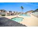 Community pool and jacuzzi surrounded by well-maintained homes and blue sky at 19815 N 49Th Ave, Glendale, AZ 85308