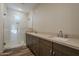 Modern bathroom with double vanity, stone counters and a glass-enclosed shower with subway tile at 2121 W Sonoran Desert Dr # 21, Phoenix, AZ 85085