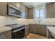 Modern kitchen with stainless steel appliances, subway tile backsplash, and wood cabinets at 2121 W Sonoran Desert Dr # 21, Phoenix, AZ 85085