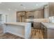 Modern kitchen with stainless steel appliances, an island, and dark wood cabinets at 2121 W Sonoran Desert Dr # 21, Phoenix, AZ 85085