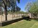 View of the backyard with a metal fence, trees, and well-maintained lawn, offering privacy and outdoor space at 2167 W Ethan Ct, San Tan Valley, AZ 85144