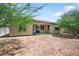 Backyard view showcasing the covered patio and spacious yard with drought tolerant landscaping at 2167 W Ethan Ct, San Tan Valley, AZ 85144