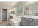 Bright bathroom featuring a soaking tub, dual sinks, and large window for natural light at 2167 W Ethan Ct, San Tan Valley, AZ 85144
