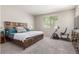 Serene bedroom featuring carpet floors, a comfortable bed, and natural light from the window at 2167 W Ethan Ct, San Tan Valley, AZ 85144