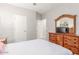 Bedroom featuring a dresser with a mirror, carpet flooring and two entryways at 2167 W Ethan Ct, San Tan Valley, AZ 85144