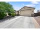 Charming single-Gathering home featuring a well-maintained lawn and an attached two-car garage with a long driveway at 2167 W Ethan Ct, San Tan Valley, AZ 85144