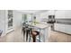 Well-lit kitchen with granite counters, stainless steel appliances, and a breakfast bar with seating at 2167 W Ethan Ct, San Tan Valley, AZ 85144