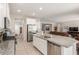 Open concept kitchen with a large island, stainless steel appliances, and adjacent living area at 2167 W Ethan Ct, San Tan Valley, AZ 85144