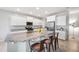 Bright kitchen featuring white cabinets, granite countertops, stainless steel appliances, and island seating at 2167 W Ethan Ct, San Tan Valley, AZ 85144